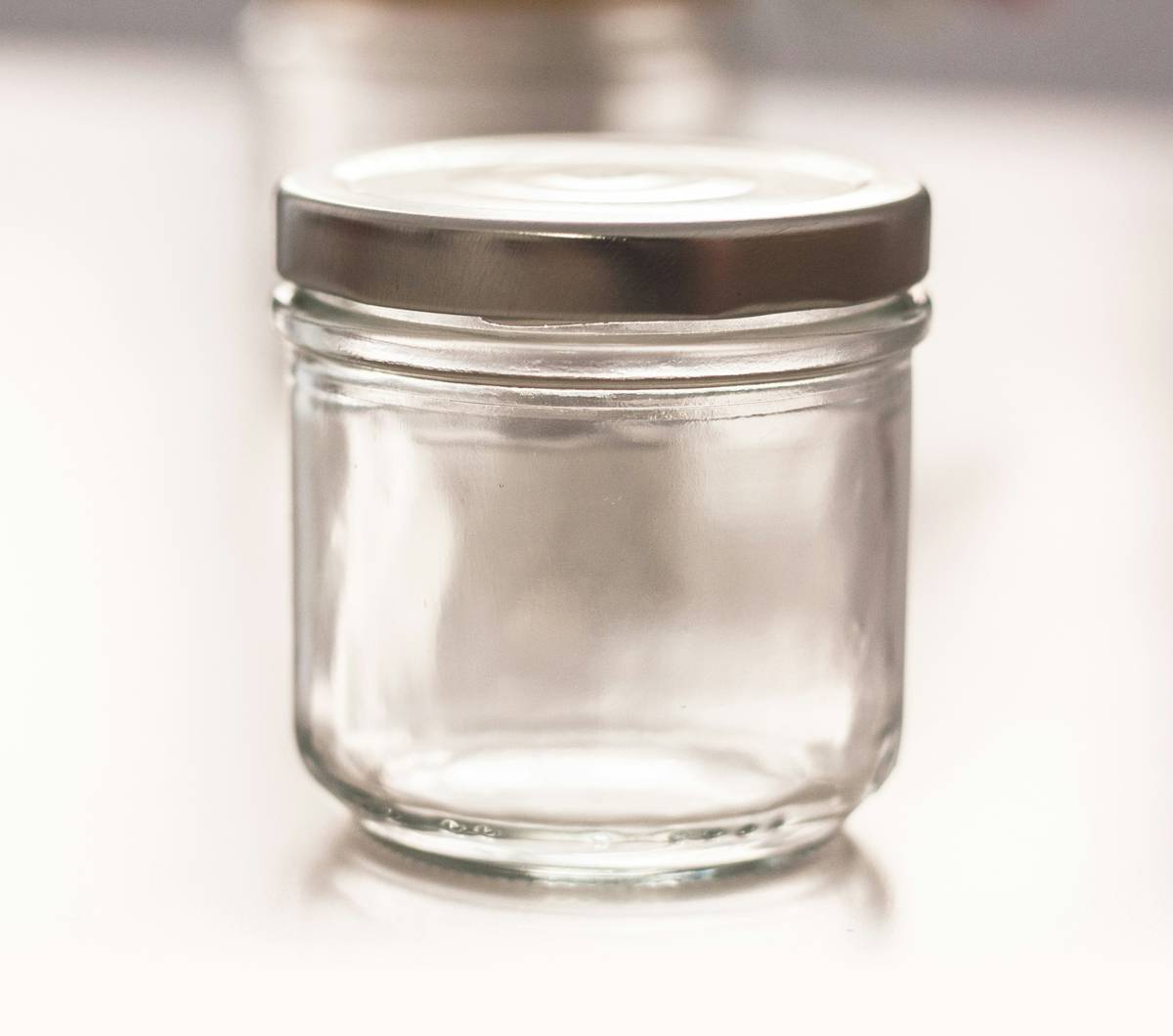 Assortment of sustainable meal prep containers made from stainless steel and glass on a kitchen counter