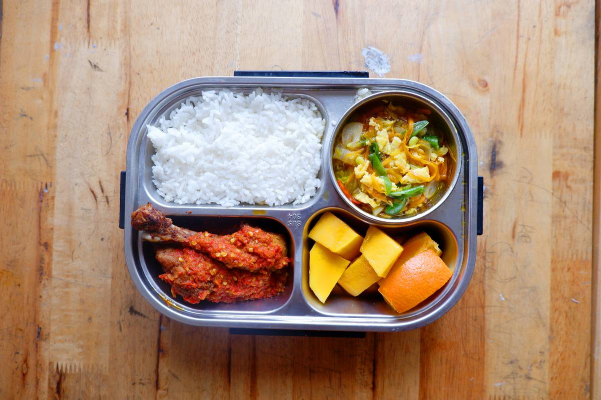 Assortment of eco friendly food containers made from stainless steel and glass on a kitchen counter
