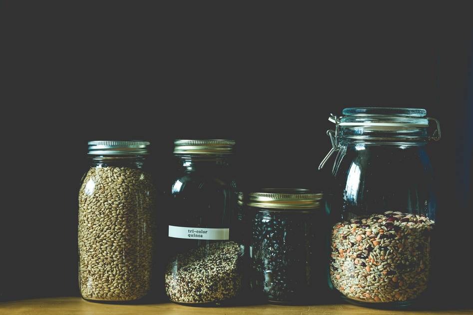 Writer preparing snacks in reusable containers at a sunlit kitchen counter